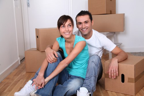 Packed boxes and furniture being loaded into a removal truck