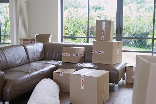 Removal team transporting desks and boxes through a Kingston office building